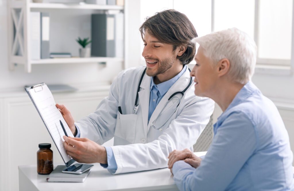 Happy Doctor Showing Positive Test Results to Patient